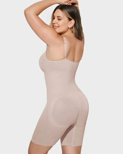 Woman wearing beige full-body shapewear bodysuit with adjustable straps, seamless design.