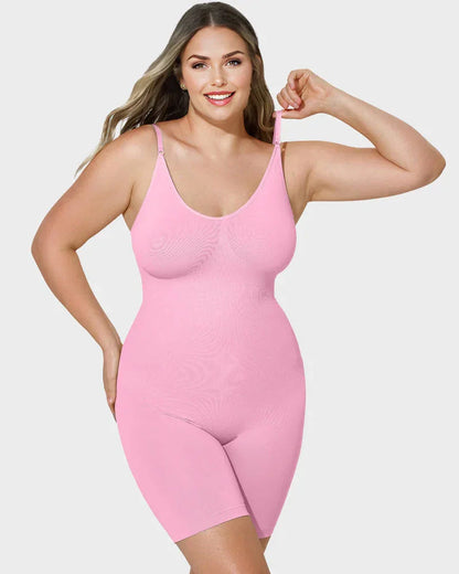 Woman wearing pink full-body shapewear bodysuit with adjustable straps on plain background