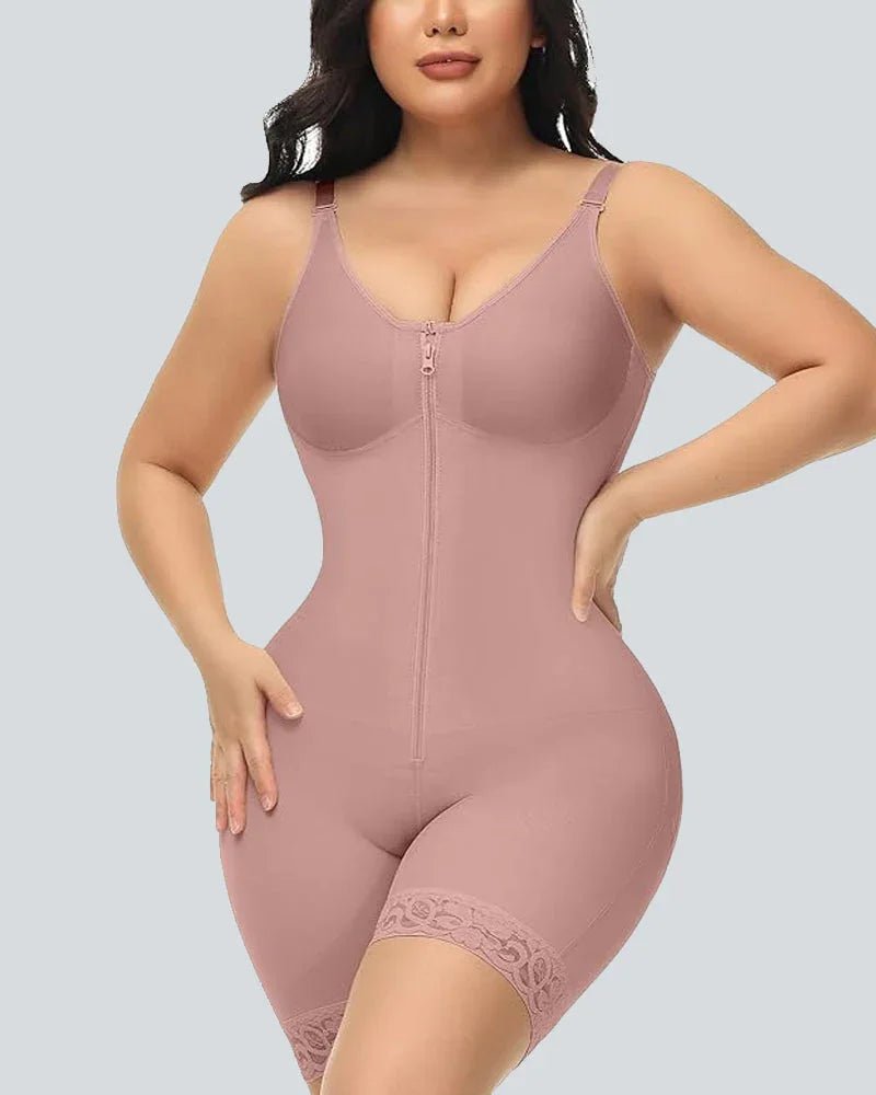 Woman wearing pink full-body shapewear with zipper front and lace trim, shaping curves