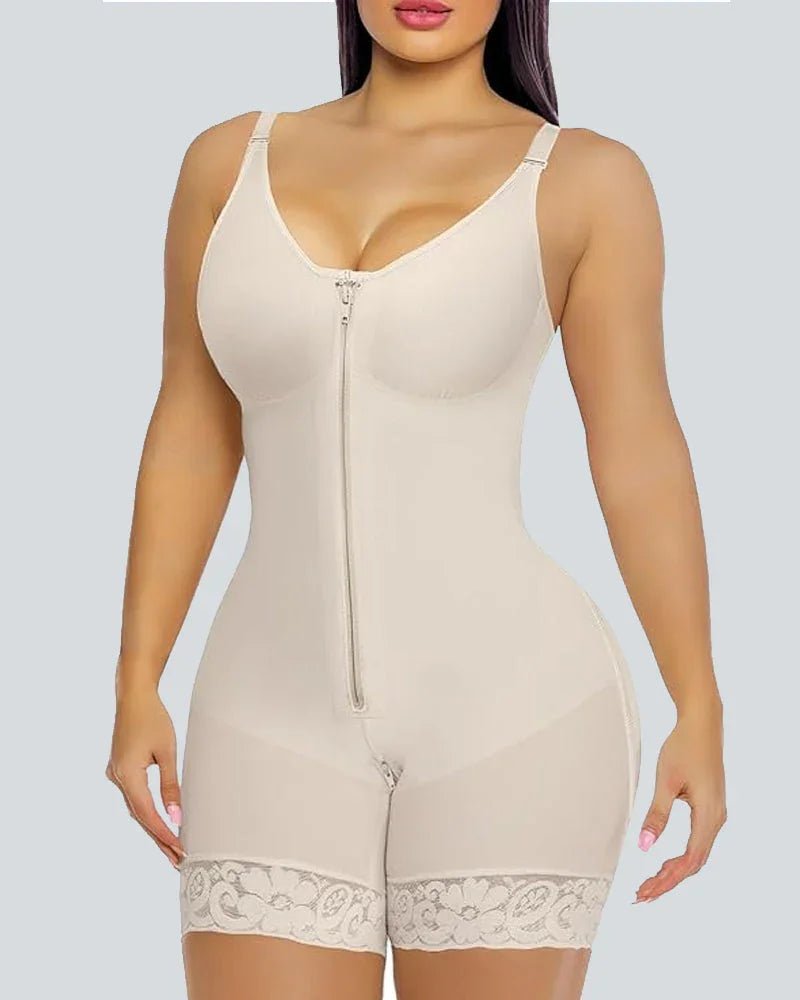 Woman wearing beige shapewear bodysuit with front zipper and lace trim on grey background.