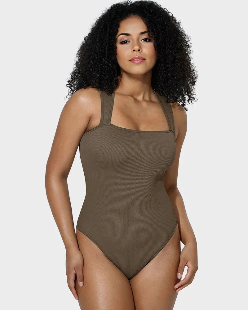 Woman modeling brown ribbed shapewear bodysuit with wide straps against white background