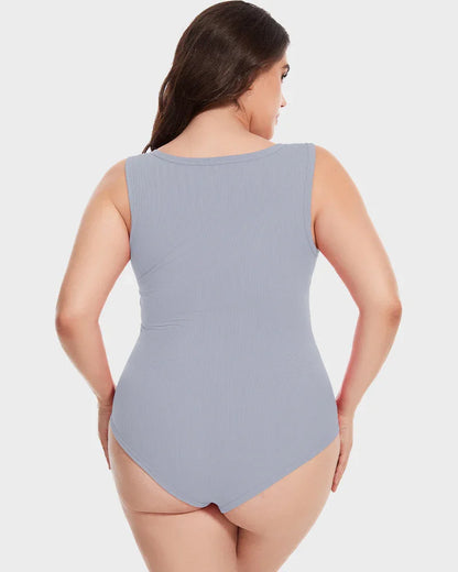 Plus size woman wearing light gray sleeveless seamless shapewear bodysuit, rear view